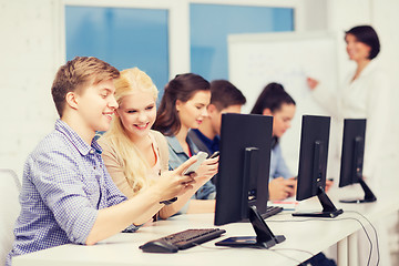 Image showing students with computer monitor and smartphones