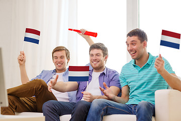 Image showing happy male friends with flags and vuvuzela