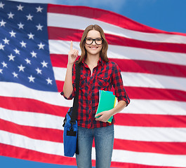 Image showing smiling female student with bag and notebooks