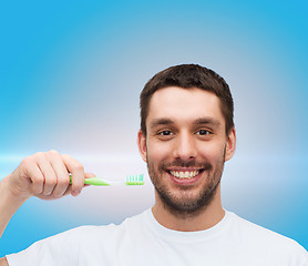 Image showing smiling young man with toothbrush