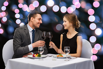 Image showing smiling couple eating main course at restaurant