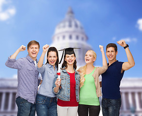 Image showing group of standing smiling students with diploma