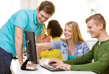 Image showing smiling students in computer class at school