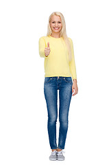 Image showing smiling girl in casual clothes showing thumbs up