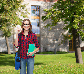 Image showing smiling female student with bag and notebooks