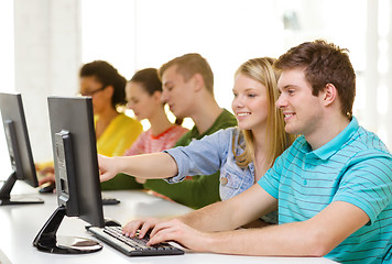 Image showing smiling students in computer class at school