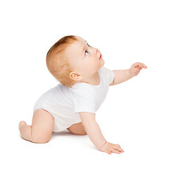 Image showing crawling curious baby looking up