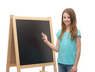 Image showing happy little girl with blackboard and chalk