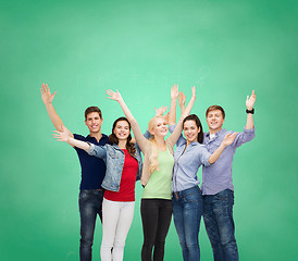 Image showing group of smiling students waving hands