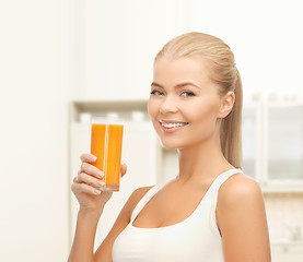 Image showing smiling woman holding glass of orange juice