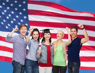 Image showing group of standing smiling students with diploma