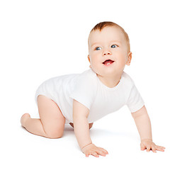 Image showing crawling smiling baby looking up