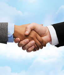Image showing businessman and businesswoman shaking hands