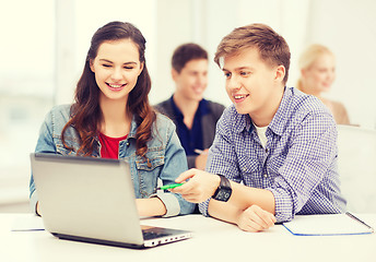 Image showing students with laptop and notebooks at school