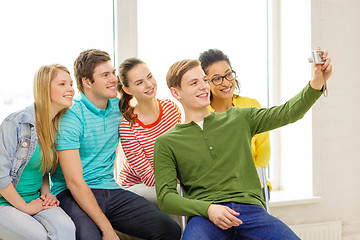 Image showing five smiling students taking picture with camera