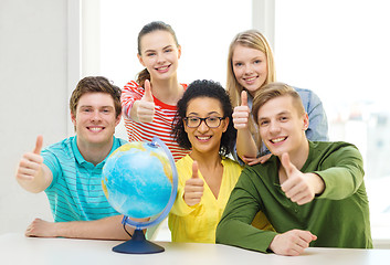 Image showing five smiling student with earth globe at school