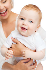 Image showing close up of mother holding smiling baby