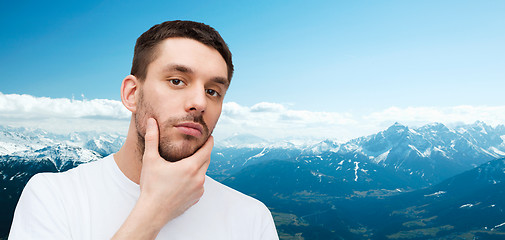 Image showing beautiful calm man touching his face