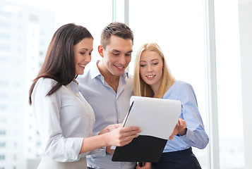 Image showing business team looking at clipboard