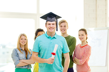 Image showing smiling male student with diploma and corner-cap