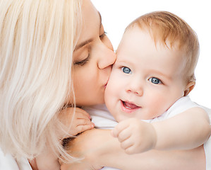 Image showing happy mother kissing smiling baby