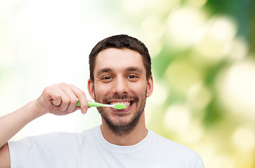 Image showing smiling young man with toothbrush