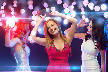 Image showing three smiling women dancing in the club