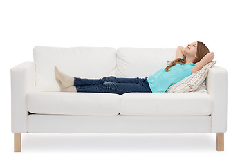 Image showing smiling little girl lying on sofa