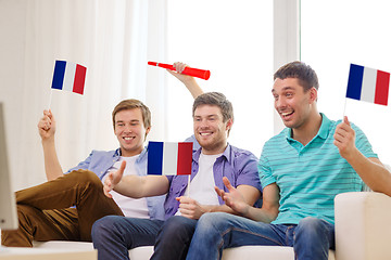 Image showing happy male friends with flags and vuvuzela