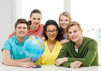 Image showing five smiling student with earth globe at school