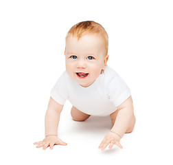 Image showing crawling smiling baby looking up