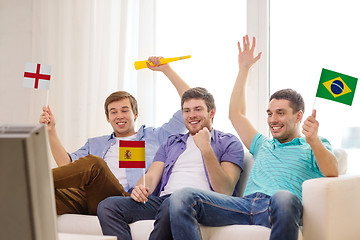 Image showing happy male friends with flags and vuvuzela