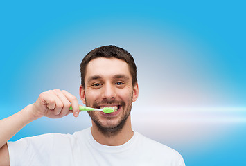 Image showing smiling young man with toothbrush