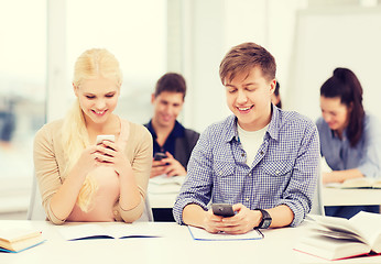 Image showing students looking into smartphone at school