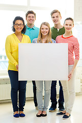 Image showing smiling students with white blank board at school