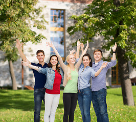 Image showing group of smiling students waving hands