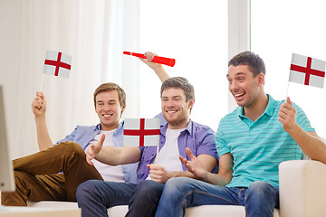 Image showing happy male friends with flags and vuvuzela