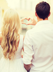 Image showing romantic couple in the city making heart shape