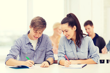 Image showing two teenagers with notebooks at school