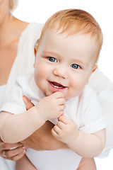 Image showing close up of mother holding smiling baby