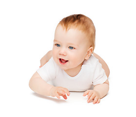 Image showing smiling baby lying on floor