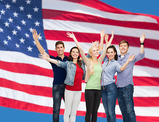 Image showing group of smiling students waving hands