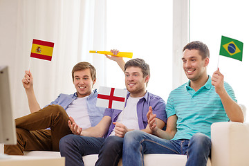 Image showing happy male friends with flags and vuvuzela