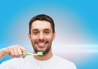Image showing smiling young man with toothbrush