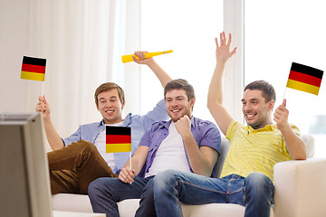 Image showing happy male friends with flags and vuvuzela