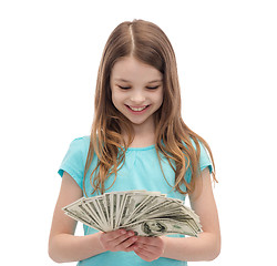 Image showing smiling little girl looking at dollar cash money