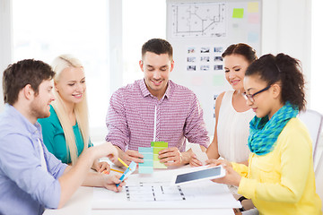 Image showing smiling interior designers working in office