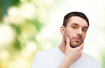 Image showing beautiful calm man touching his face