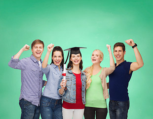 Image showing group of standing smiling students with diploma