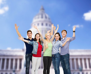 Image showing group of smiling students waving hands